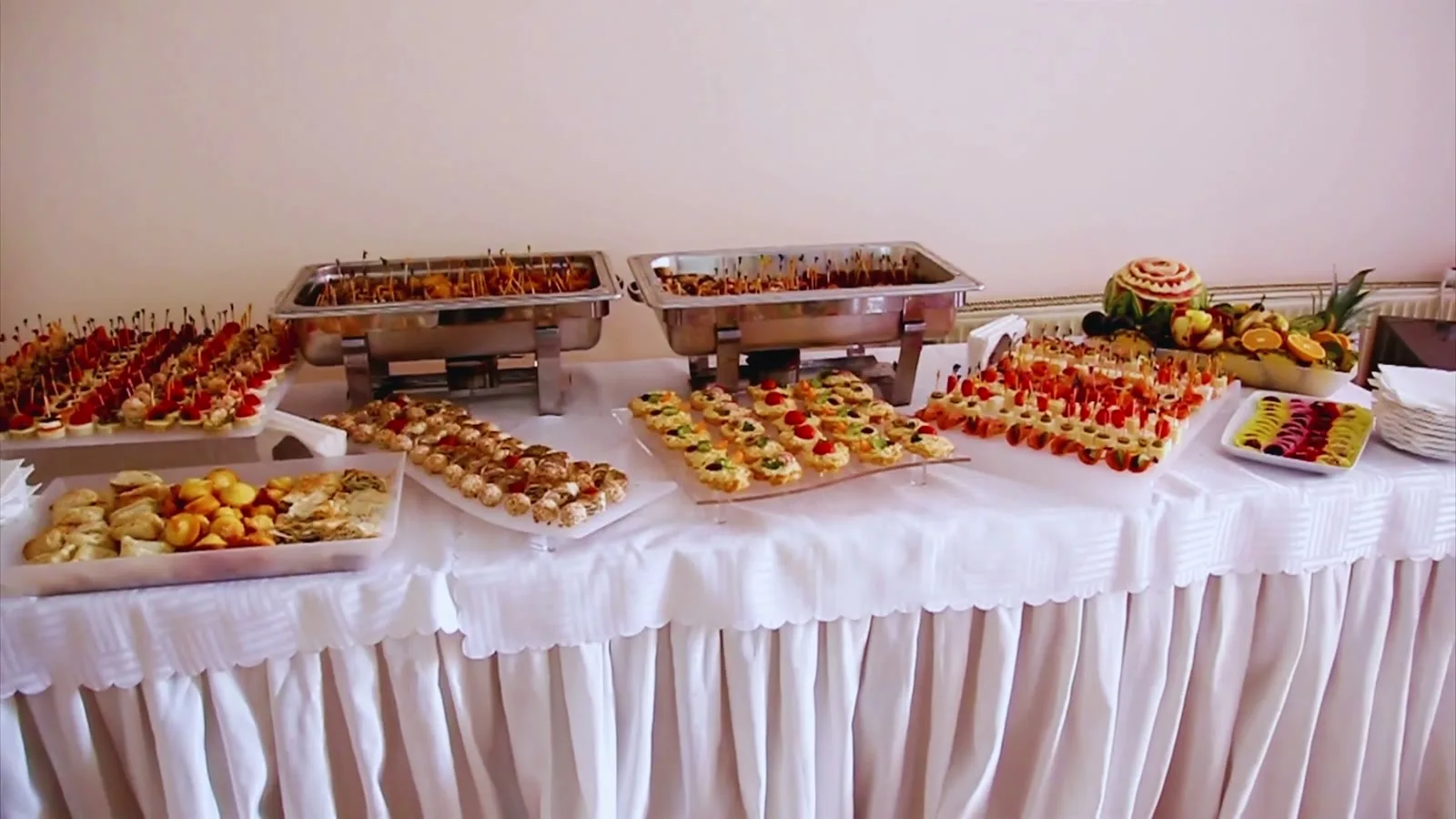 Weiß eingedeckte Fingerfood-Tafel mit Canapés und Häppchen
